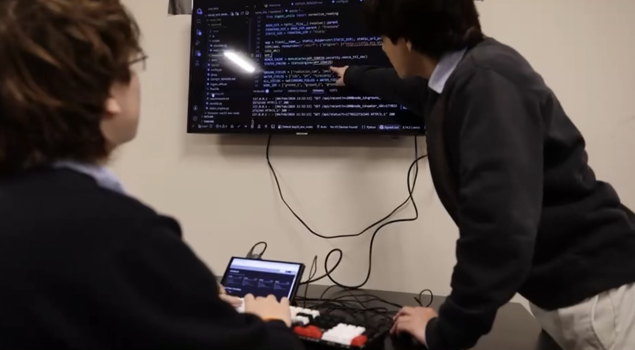 Students building and programming robotics systems